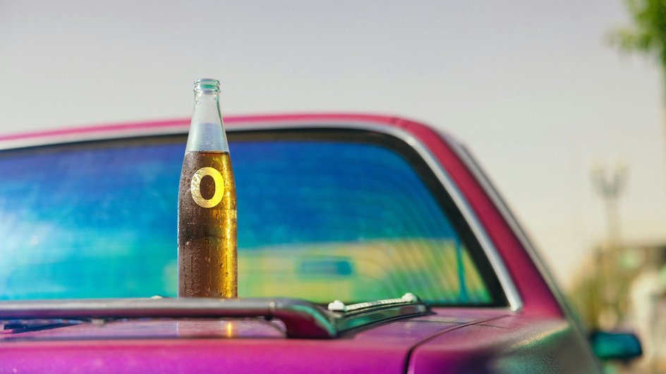 Безалкогольное пиво на багажнике красного автомобиля
