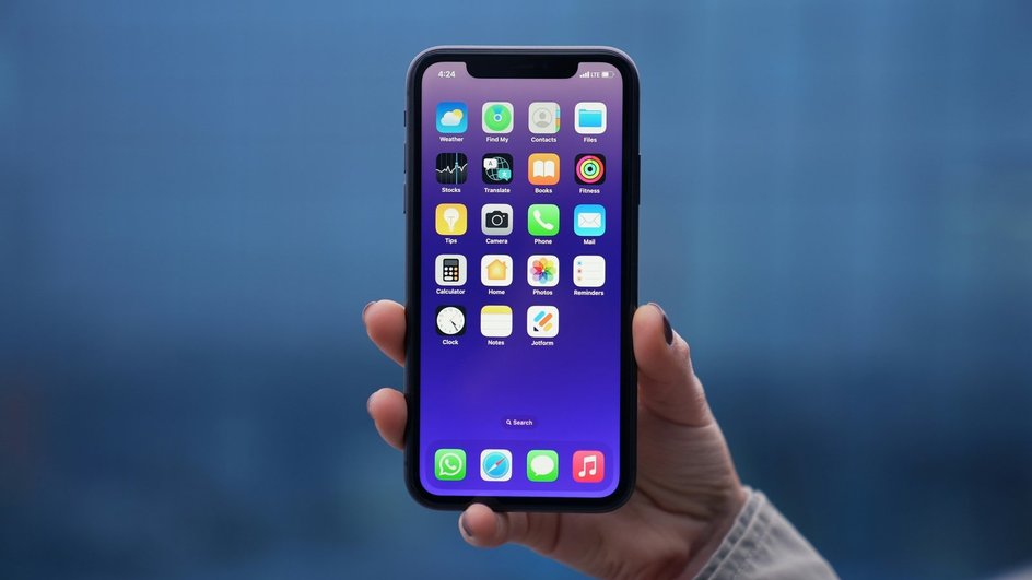 Женщина держит iPhone в руке Женщина держит iPhone в руке