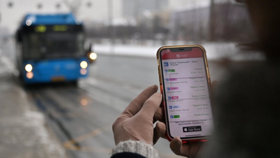 Пассажир просматривает актуальное расписание маршрута автобуса на остановке общественного транспорта