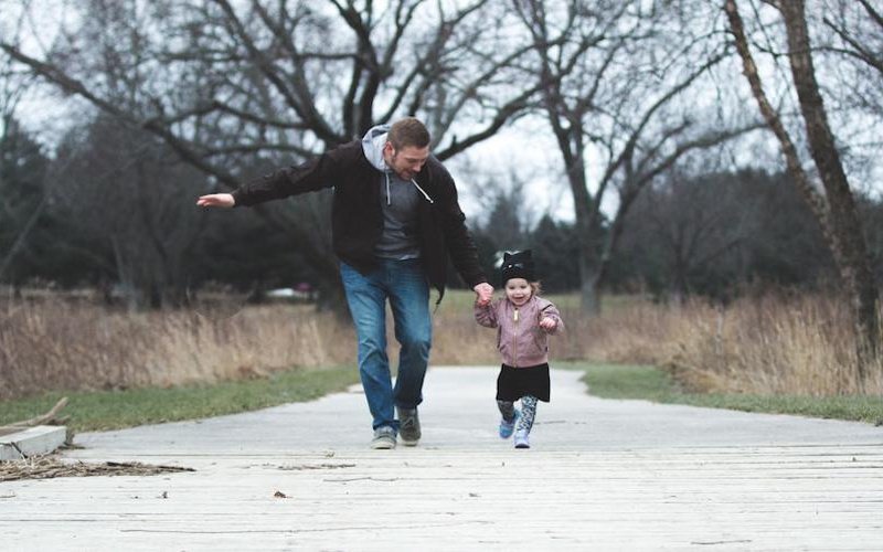 photo-of-father-and-daughter-running-at-the-park-853408