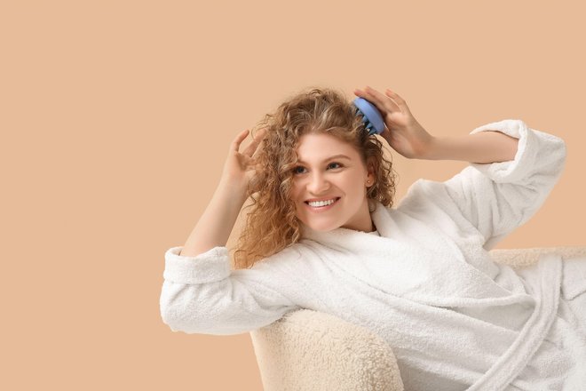 девушка расчесывает кудрявые волосы девушка расчесывает кудрявые волосы