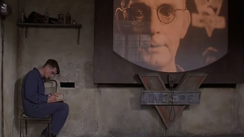 В романе Джорджа Оруэлла «1984» и его экранизациях уже появлялись устройства под названиям «Телекранs» (англ. Telescreen). Их использовали для пропаганды и слежки за населением. Кадр из фильма «1984» Майкла Рэдфорда.