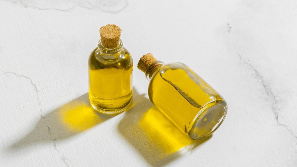 На белом столе две бутылки тыквенного масло с качественным составом и степенью очистки.