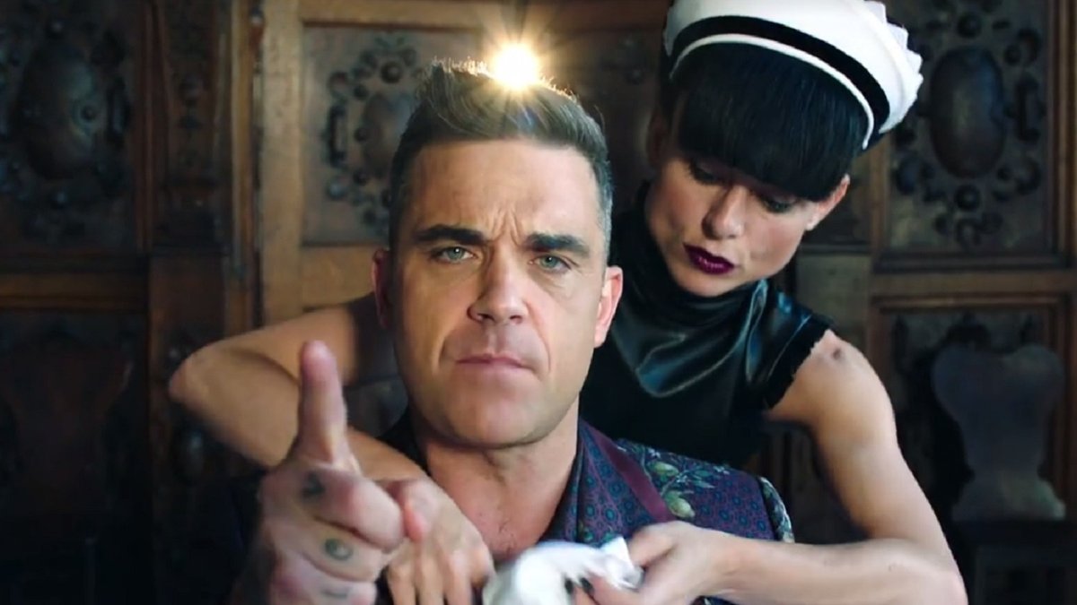 Robbie williams russian. Робби Уильямс мелодрамы. Робби Уильямс клип про русских. Роби Вильямс песня о русских. Робби Уильямс клип про разгульную вечеринку.